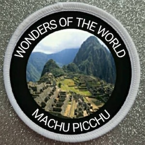 May include: A white and black circular patch with the text "Wonders of the World" and "Machu Picchu" around a photo of Machu Picchu.