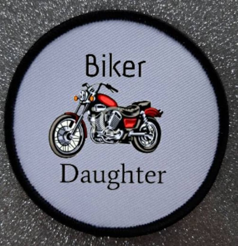 May include: White round patch with black trim featuring a red motorcycle with the text "Biker Daughter" in black.