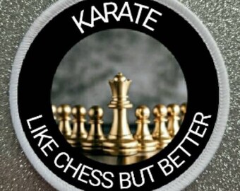 May include: White round patch with black border and white text that reads "KARATE LIKE CHESS BUT BETTER". The center of the patch features a photo of gold chess pieces with the king in the center.