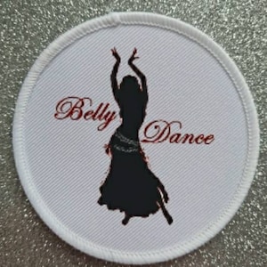 May include: White round patch with red embroidered text "Belly Dance" and a black silhouette of a woman dancing.