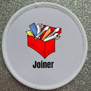 May include: White round patch with a red toolbox filled with tools and the word "Joiner" in black text.