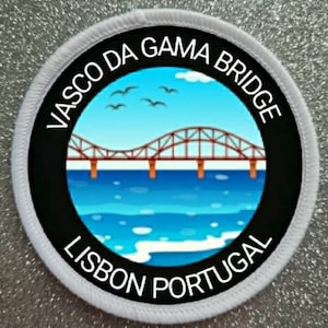 May include: Round patch featuring the Vasco da Gama Bridge in Lisbon, Portugal. The design includes a blue sky with birds, a brown bridge, and blue water. The text "VASCO DA GAMA BRIDGE" and "LISBON PORTUGAL" are in white.