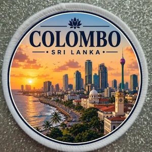 May include: A circular embroidered patch featuring a sunset cityscape of Colombo, Sri Lanka. The design includes the text COLOMBO SRI LANKA in dark blue letters, a lotus icon, a coastal road, palm trees, and a tall tower against an orange sky.