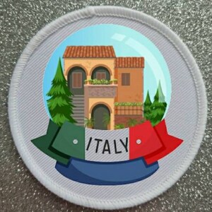May include: A white round patch with a colorful image of a building with a red roof and green trees. The building has a white balcony and a blue door. The image is surrounded by a green, white, and red ribbon with the word "ITALY" in black letters.
