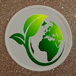 May include: White round patch with a green leaf design and a green globe with continents outlined in white.