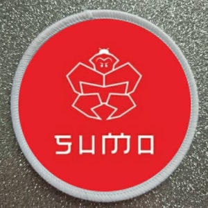 May include: A white and red round patch with a white stylized logo of a crab with the word "SUMMO" written below it.
