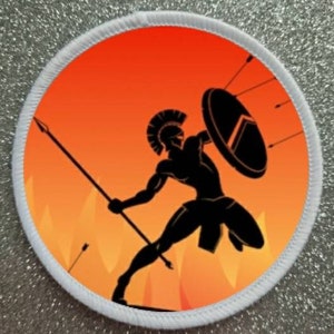 May include: A white round patch with a red and orange background. A black silhouette of a warrior with a shield and spear stands in front of a fiery orange background.