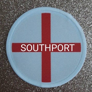 May include: A white and red round patch with a red cross and the text "SOUTHPORT" in white.