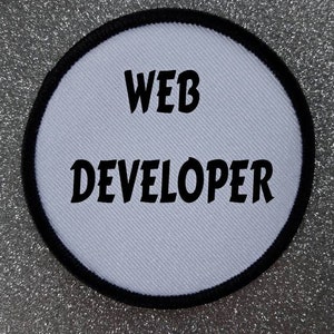 May include: White round patch with black border and text "WEB DEVELOPER" in black.