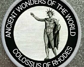 May include: Black and white embroidered patch with the text "Ancient Wonders of the World Colossus of Rhodes". The patch features a black and white illustration of a statue of a man.