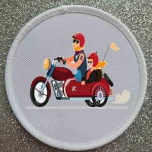 May include: Circular patch depicting a red motorcycle with a sidecar. The driver and passenger are wearing red helmets and sunglasses. The motorcycle has a yellow headlight and a small yellow flag. The patch has a white border.
