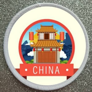 May include: A white and red circular patch with a white border. The centre of the patch features a cartoon illustration of a traditional Chinese building with red lanterns. The text "CHINA" is written in black letters on a red banner.