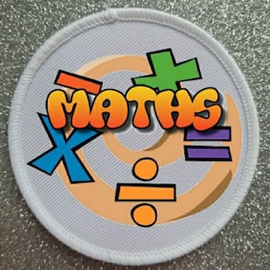 May include: White round patch with a brown swirl design and colorful math symbols. The word "MATHS" is written in orange and yellow letters.