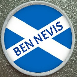 May include: A white and blue round patch with a white diagonal cross and the text "BEN NEVIS" in black letters.