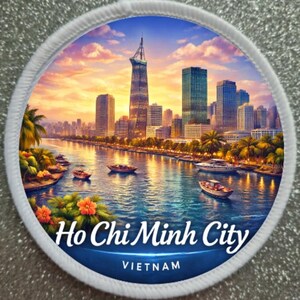 May include: Round patch featuring a scenic view of Ho Chi Minh City, Vietnam. The image depicts a cityscape with skyscrapers, a river with boats, and a vibrant sunset. The text "Ho Chi Minh City" and "Vietnam" are displayed.