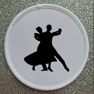 May include: A circular white patch featuring a black silhouette of a dancing couple. The patch has a white stitched border and a light grey background. The dancers are in a ballroom dance pose.