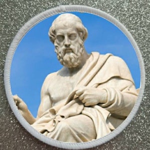 May include: A white marble statue of a man with a beard and a toga, against a blue sky background.