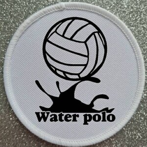 May include: White round patch with a black and white water polo ball splashing into water. The text "water polo" is printed below the ball.
