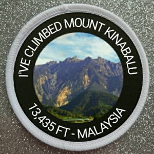 May include: White round patch with black text and a photo of Mount Kinabalu in Malaysia. The text reads "I've Climbed Mount Kinabalu 13,435 FT - Malaysia".