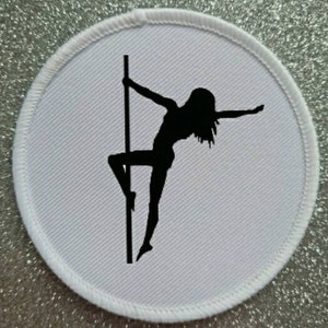 May include: White round patch with a black silhouette of a person pole dancing.