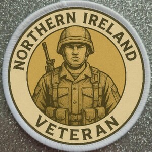 May include: Round patch with a sepia-toned illustration of a soldier in uniform, holding a rifle. The text "NORTHERN IRELAND VETERAN" is in a circular pattern around the image.
