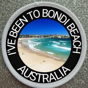 May include: A white and black circular patch with the text "I've Been To Bondi Beach Australia" around a photo of Bondi Beach, Australia.