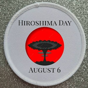 May include: White round patch with black text that reads "Hiroshima Day August 6". A red circle with a black mushroom cloud graphic is in the center.