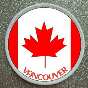 May include: A white and red Canadian flag patch with a red maple leaf and the word "VANCOUVER" in red lettering.
