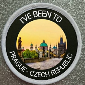 May include: White round patch with black text that reads "I've Been To Prague - Czech Republic". The patch features a photo of the Charles Bridge in Prague, Czech Republic at sunset.
