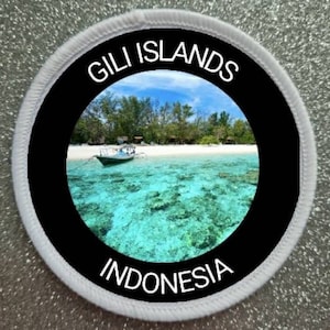 May include: A white and black round patch with the text "Gili Islands Indonesia" and a photo of a tropical beach with turquoise water and a boat.