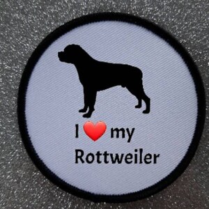 May include: White round patch with a black silhouette of a Rottweiler dog and the text "I love my Rottweiler" with a red heart.