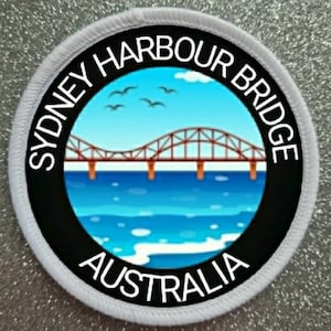 May include: A white circular patch with black text and a colorful image of the Sydney Harbour Bridge. The text reads "Sydney Harbour Bridge Australia".