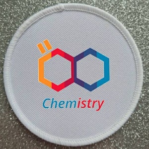 May include: White round patch with a colorful hexagonal logo and the word "Chemistry" printed below. The logo is made up of two hexagons, one orange and red, the other blue and purple, connected together.
