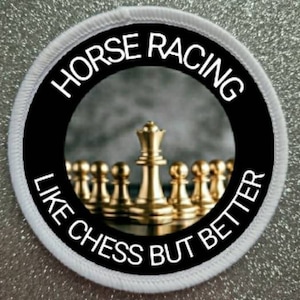 May include: A white round patch with black text that reads "Horse Racing Like Chess But Better". The center of the patch features a close-up of a gold chess set with the king in the center.