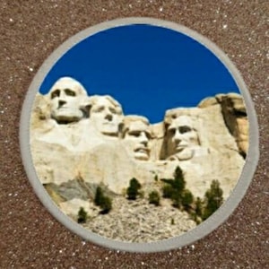 May include: A close-up view of Mount Rushmore National Memorial, a large sculpture carved into a granite mountain in South Dakota, USA. The sculpture features the faces of four U.S. presidents: George Washington, Thomas Jefferson, Theodore Roosevelt, and Abraham Lincoln.