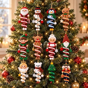 May include: A collection of eleven crocheted Christmas ornaments hanging on a tree. The figures include Santa, a snowman, a penguin, a gingerbread person, an elf, a reindeer, Mrs. Claus, a gnome, an angel, a polar bear, and a nutcracker.