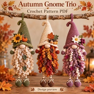 May include: Three crocheted gnome ornaments hanging from a branch, labeled Autumn Gnome Trio Crochet Pattern PDF. The gnomes feature pointed hats in olive green, cream, and purple, adorned with sunflowers, leaves, and acorns.