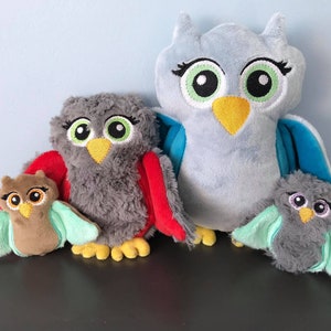 May include: Four plush owl toys in different colors and sizes. The largest owl is light blue with yellow beak and green eyes. The second largest owl is gray with red wings and yellow beak. The smallest owl is brown with green wings and yellow beak. The fourth owl is gray with green wings and yellow beak.