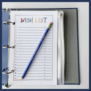 May include: A blue binder with a "WISH LIST" page and a blue pencil. The wish list has numbered lines with dollar signs. The pencil is angled across the page. The binder has a clear pocket and a zipper.