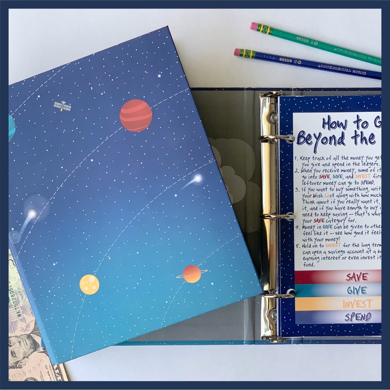 May include: A blue binder with a space-themed cover featuring planets and stars. Inside, a page titled "How to Go Beyond the Budget" lists financial tips. Colored tabs read "Save," "Give," "Invest," and "Spend." Pencils rest on top.
