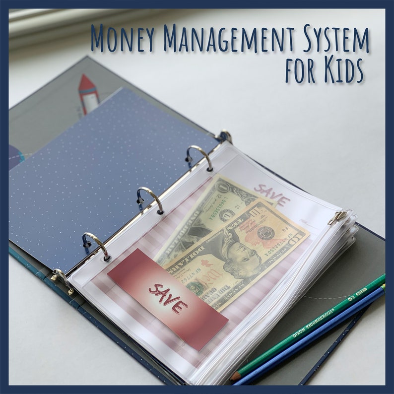 May include: An open binder with the text "MONEY MANAGEMENT SYSTEM FOR KIDS" at the top. Inside, a clear pocket holds two dollar bills and a card that says "SAVE". Colored pencils are visible on the right.
