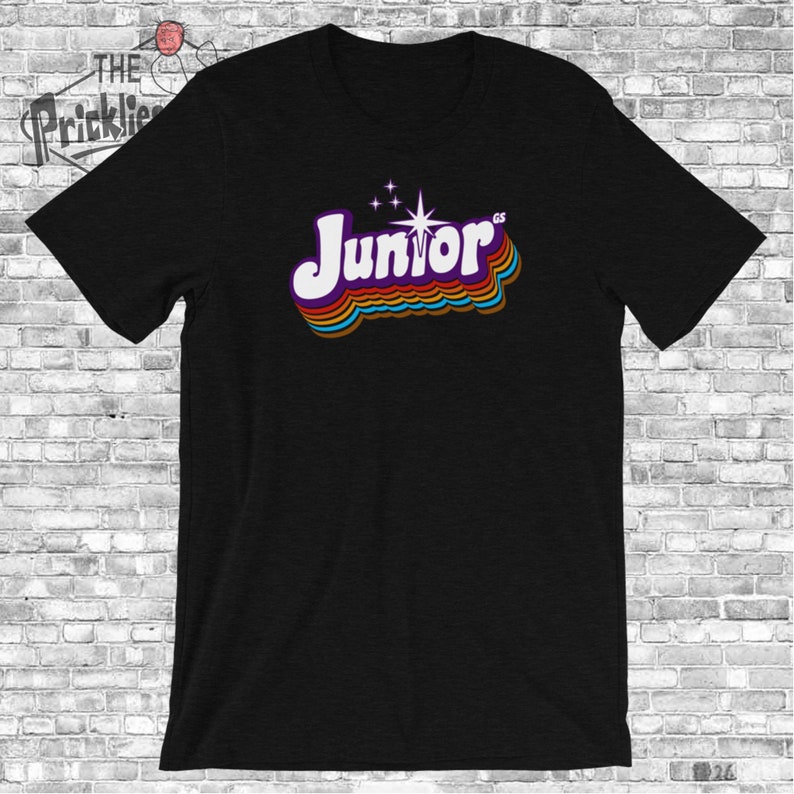May include: Black t-shirt with a retro-style graphic of the word "Junior" in rainbow colors with a star above it.