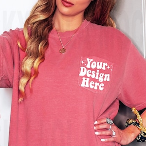 May include: A pink t-shirt with a pocket that says "Your Design Here" on it.