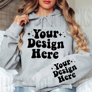 May include: A gray hooded sweatshirt with the text "Your Design Here" printed on the front and sleeve. The text is in a retro, bold font.