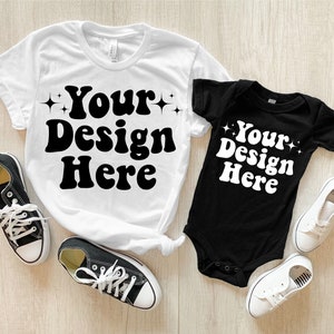 May include: A white t-shirt and a black bodysuit with the text "Your Design Here" in a retro font. Both shirts have small stars on either side of the text.