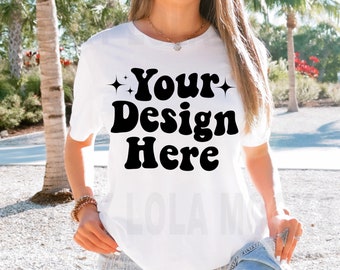 May include: White t-shirt with the text "Your Design Here" in black retro font with stars on either side of the text.