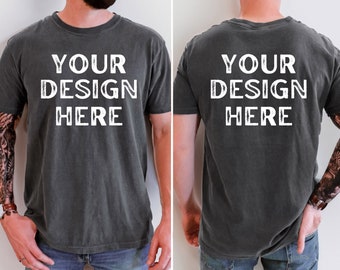 May include: A dark gray t-shirt with the text "YOUR DESIGN HERE" printed in white on the front and back.