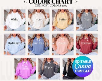 以下が含まれることがあります： Comfort Colors 1467パーカーのカラーチャート。ホワイト、アイボリー、バター、グレー、ハイドレンジア、ブルージーン、ピーチ、クリムゾン、ネオンバイオレット、ペッパー、ブラックの10色展開。各パーカーには白いドローストリングとフードが付いています。