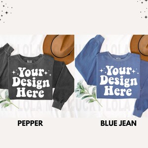 May include: Two sweatshirts with the text "Your Design Here" in a retro font. The sweatshirt on the left is a dark gray color and the sweatshirt on the right is a light blue color.