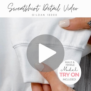 May include: Close-up of a white sweatshirt sleeve. The text "Sweatshirt Detail Video" is at the top, with "GILDAN 18000" below it. A circular play button is in the center. A white circle with the text "MALE & FEMALE Model TRY ON INCLUDED!" is on the right.